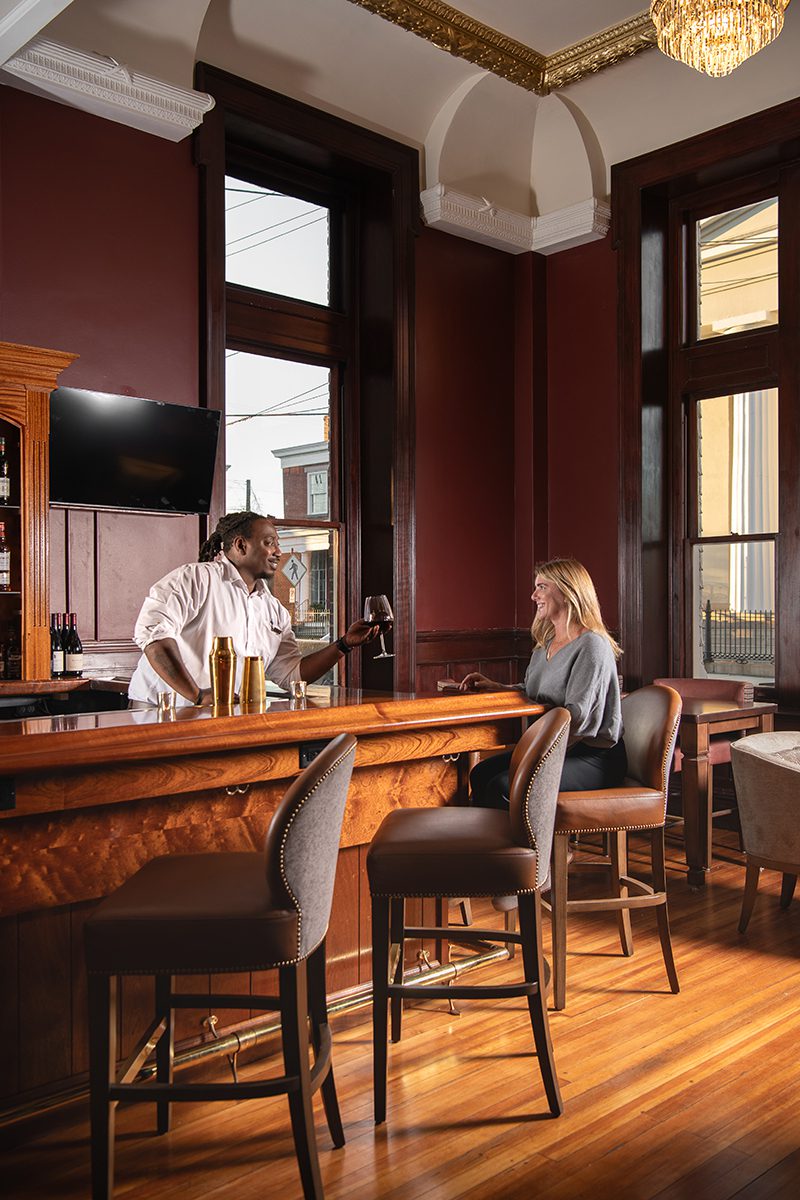 white woman and African American bartender at bar