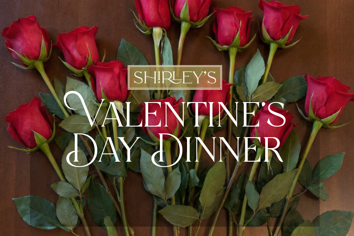 red roses on a dark wood table